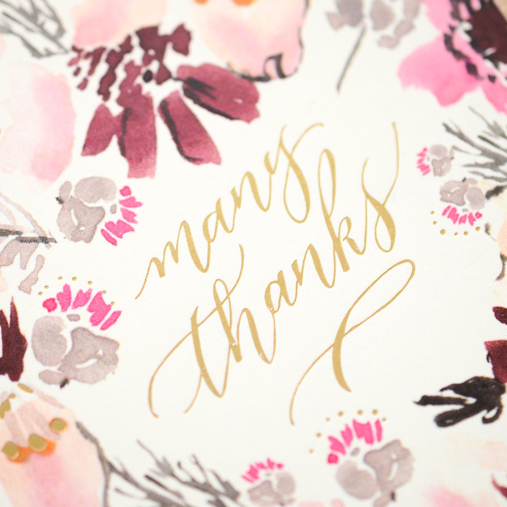 Thank you card with a vibrant watercolor floral design and 'Many Thanks' in gold script.