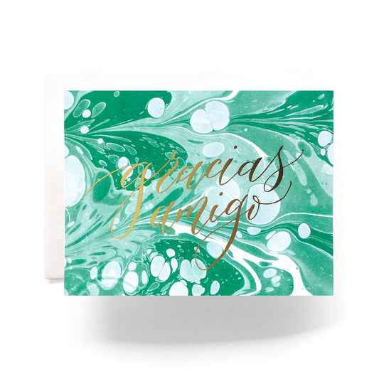 Thank you card with a marble background and 'Gracias Amigo' in stylish, bold lettering