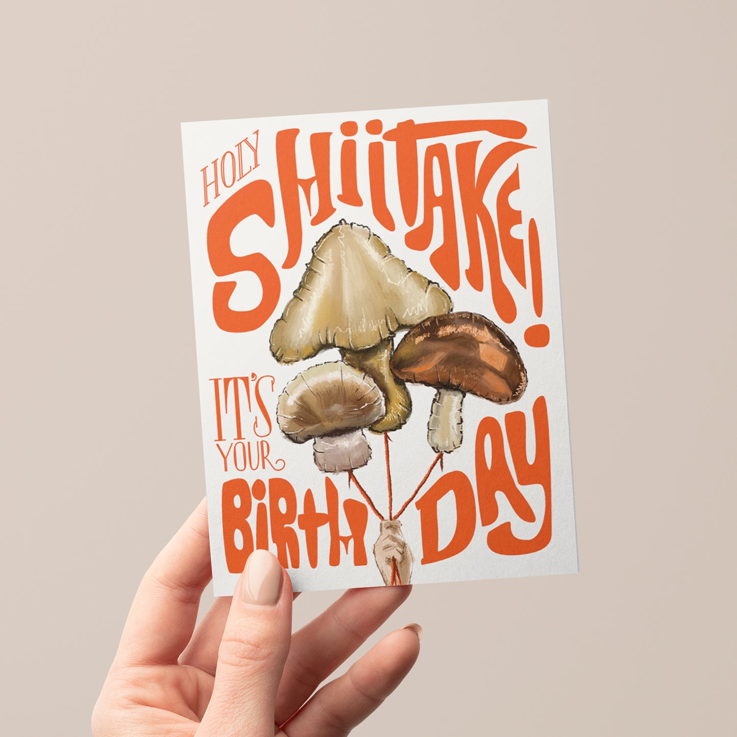 Humorous birthday card featuring a playful mushroom balloons with the phrase 'Holy Shiitake,' perfect for a lighthearted celebration.