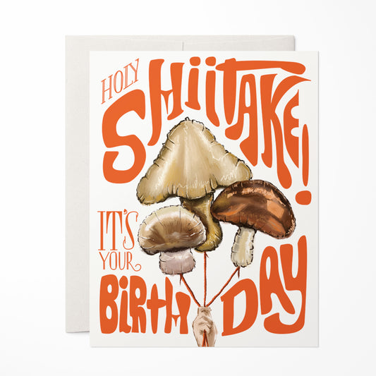 Humorous birthday card featuring a playful mushroom balloons with the phrase 'Holy Shiitake,' perfect for a lighthearted celebration.