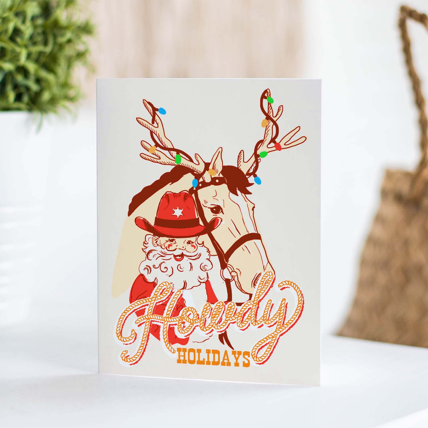 Howdy holidays Santa holiday card, with a cheerful cowboy Santa, perfect for a western holiday greeting, blank inside.