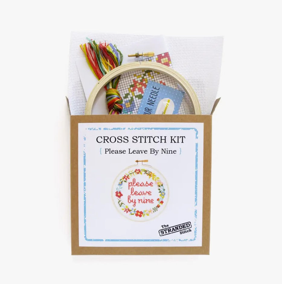 Cross stitch kit with fabric, wooden hoop, thread, needle, and instructions for beginners, saying "please leave by nine".