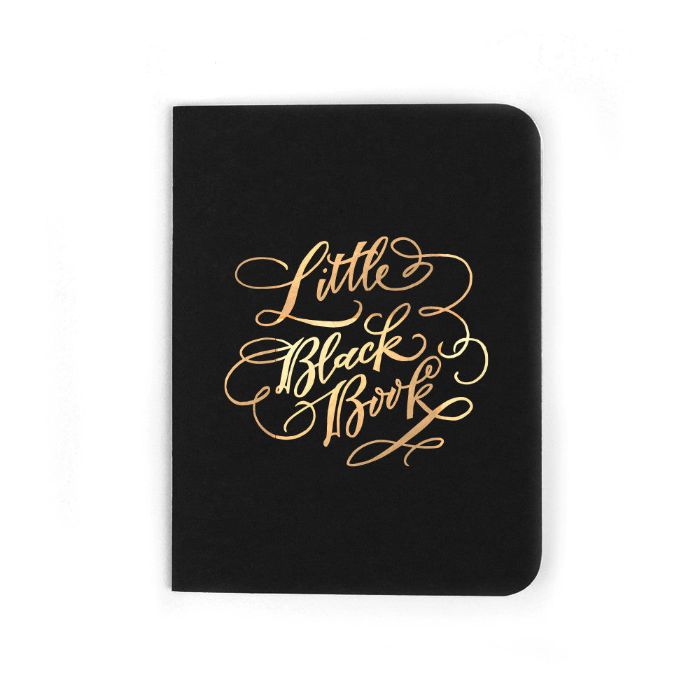 Black softcover staple-bound notebook with "little black book" and gold accents