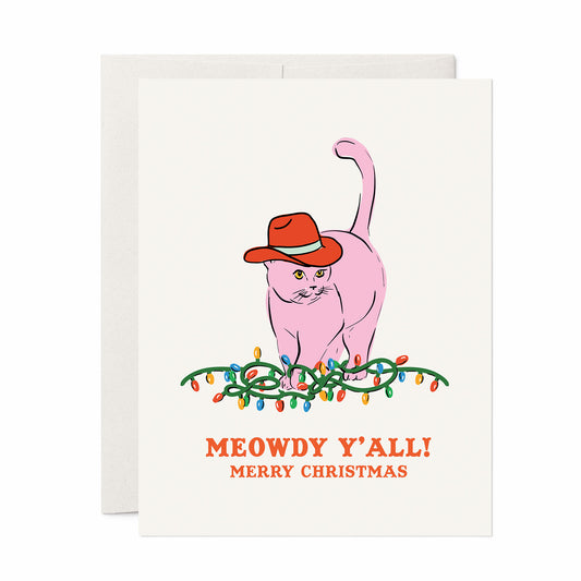 Christmas card with a pink cat wearing a red cowboy hat sitting on Christmas lights and the text “Meowdy Y’all! Merry Christmas.”