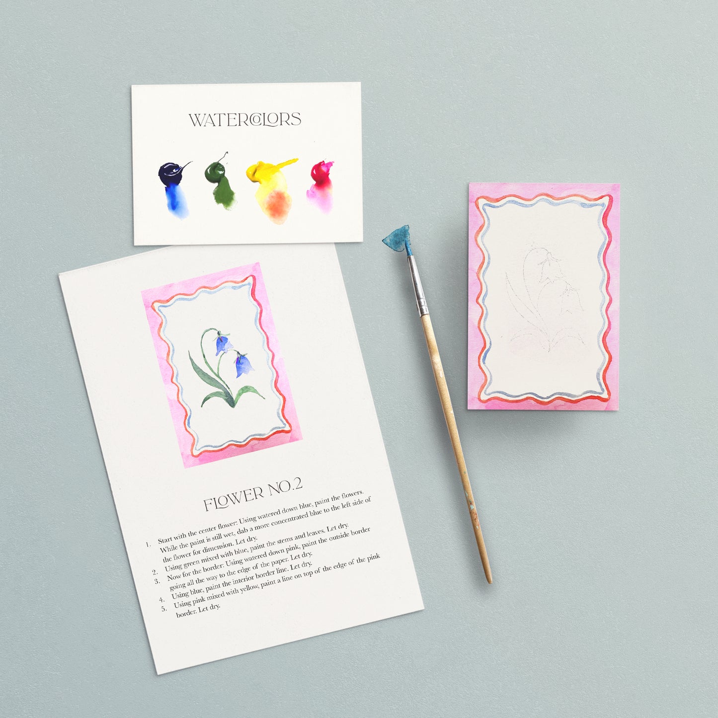 Artistic watercolor cards with a paintbrush on a gray background