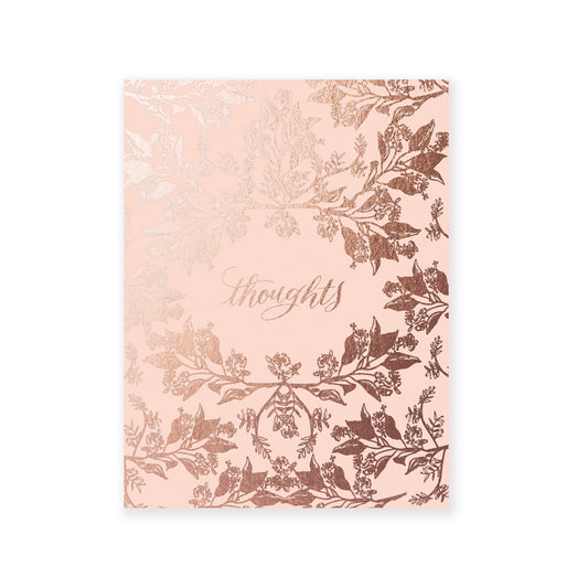 Pink softcover staple-bound notebook with floral pattern and gold accents