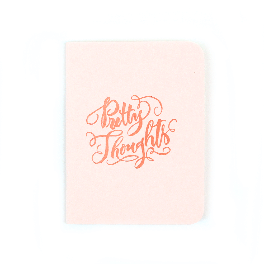 Pink softcover staple-bound notebook with "pretty thoughts" and gold accent