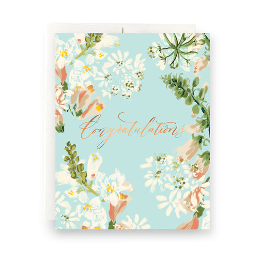 Light blue greeting card with delicate floral design and gold script "congrats." Blank interior, perfect for graduations, new jobs, or any special occasion.