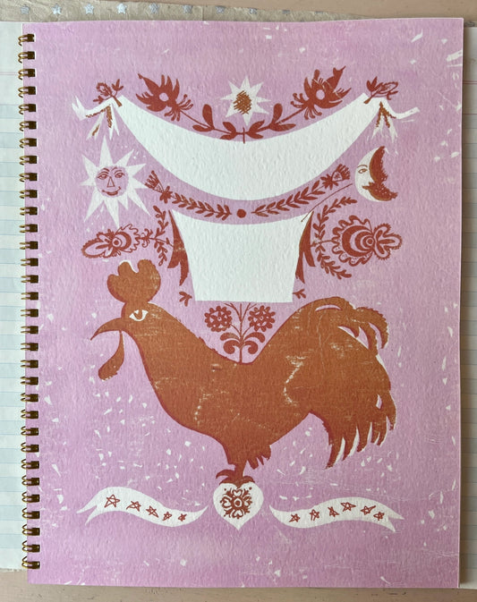 colorful softcover spiral-bound notebook featuring a rooster inspired design. lined interior pages. 