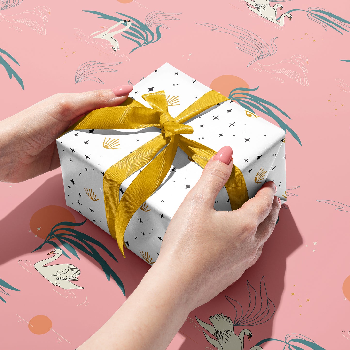 Recycled double-sided gift wrap with modern geometric patterns in and fun swan designs, ideal for eco-conscious gift-giving.