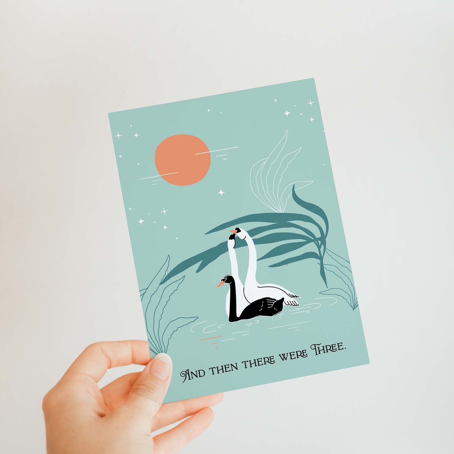 Illustration of three swans on a lake with a blank greeting card for a new baby.