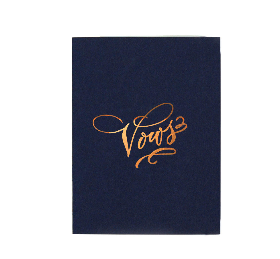 Navy softcover staple-bound notebook with "vows" and gold accents