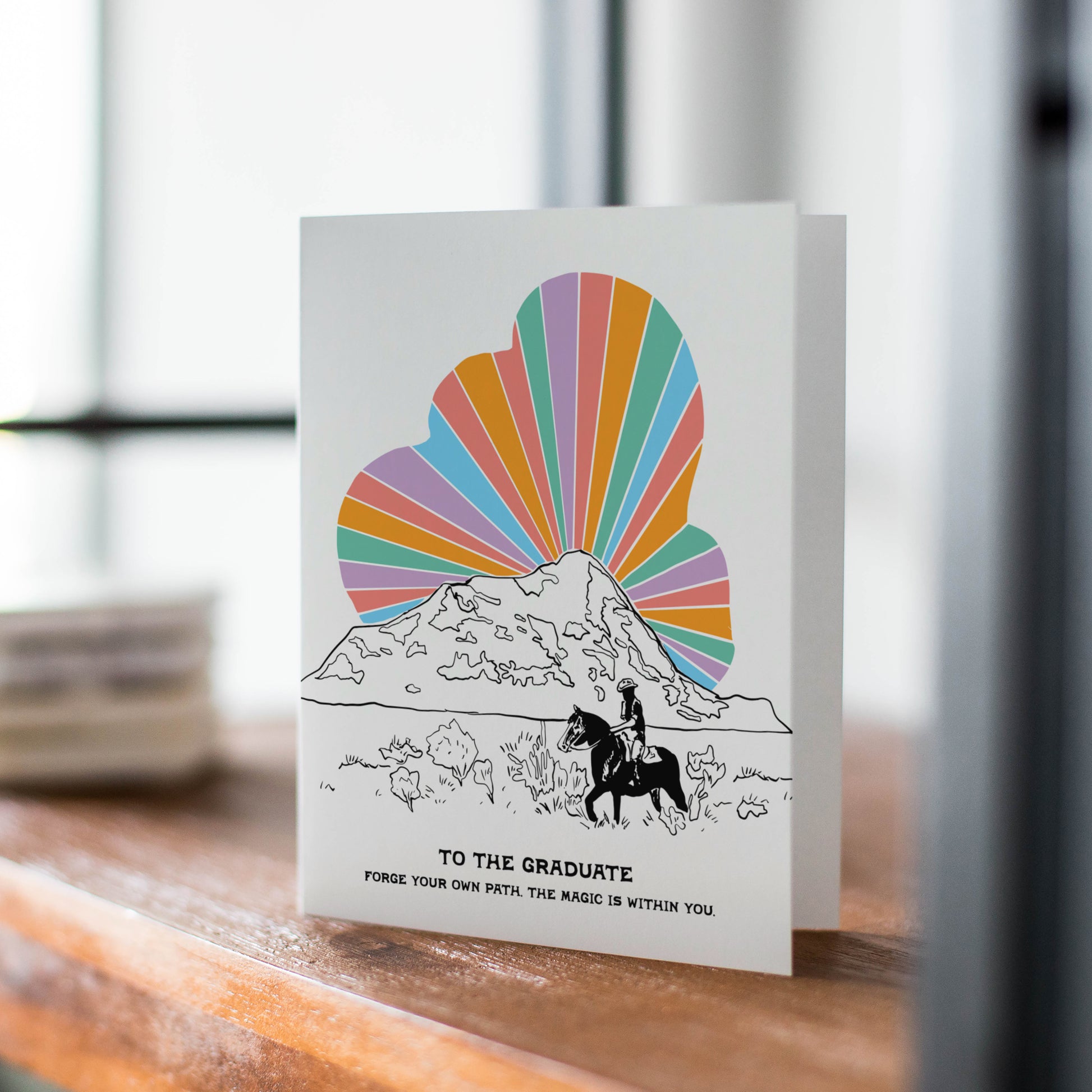 Cosmic Cowboy Grad card with a unique western theme, with a rainbow cloud ideal for graduates with a sense of adventure.