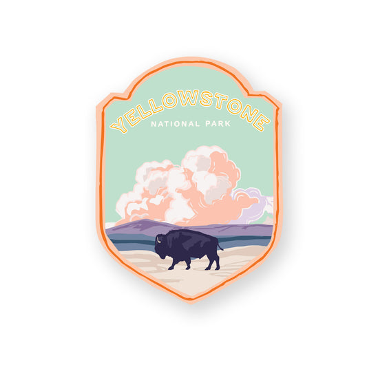 A Yellowstone National Park sticker featuring the iconic buffalo, including steaming geysers, and mountains, perfect for outdoor enthusiasts and nature lovers.