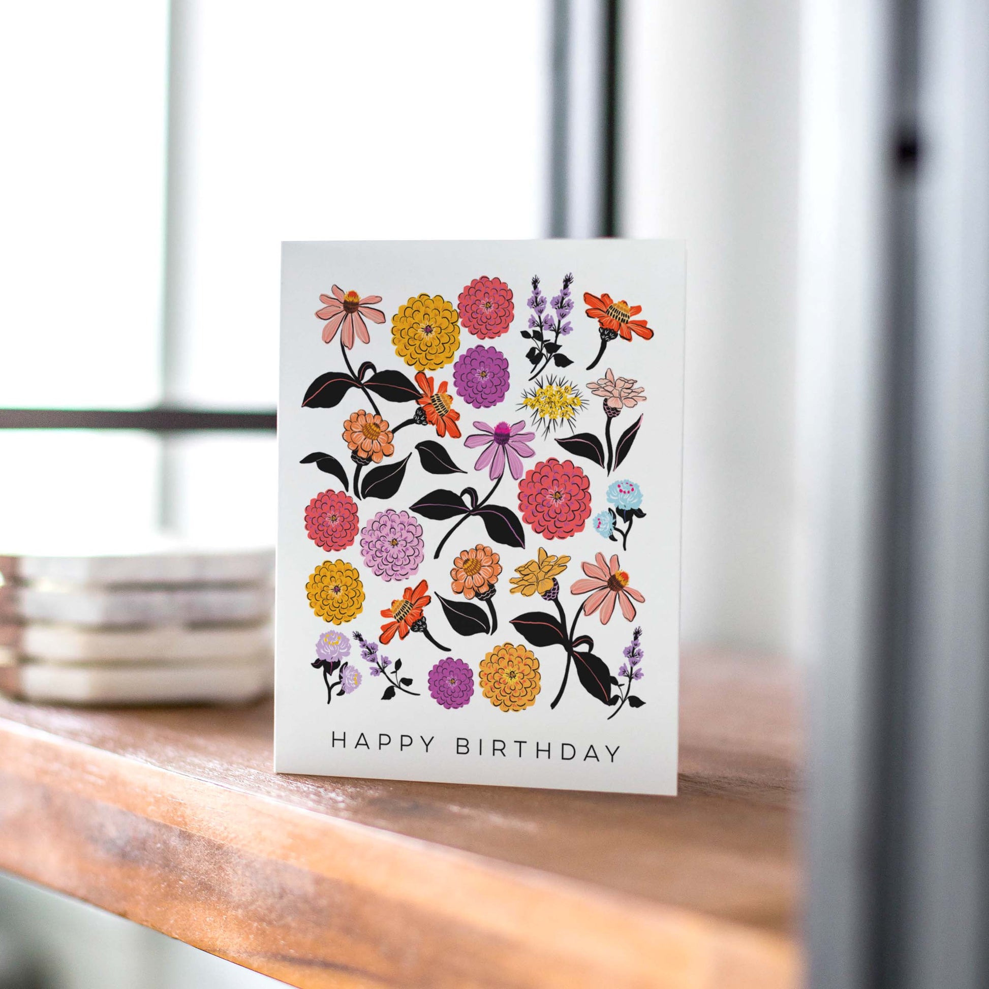 Bright and cheerful birthday card featuring illustrations of colorful zinnias, celebrating the beauty of flowers and perfect for garden lovers.